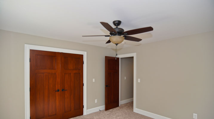 ICH Builders Mt. Sterling residence custom build upstairs bedroom with custom designed doors and ceiling fan